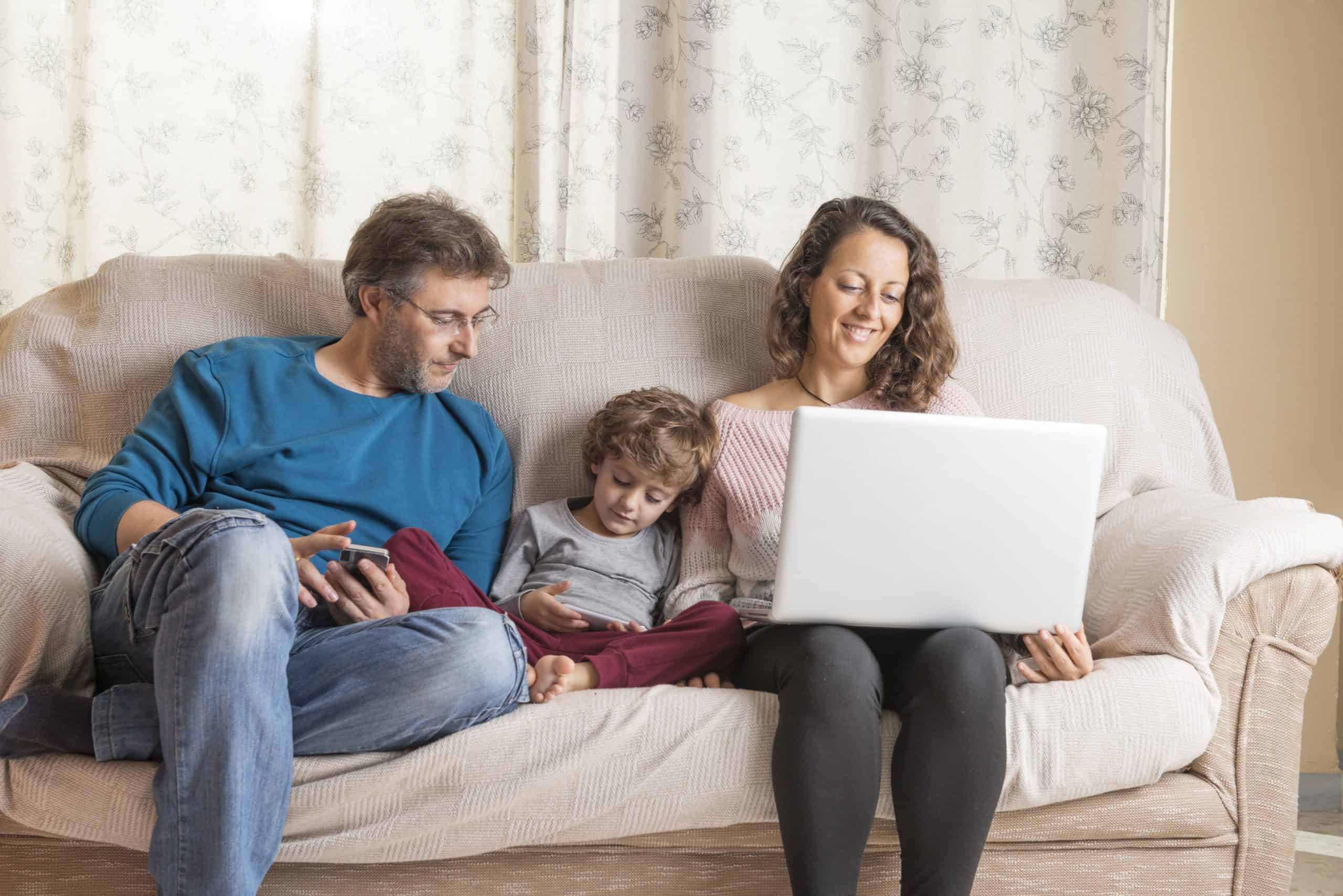 A family participating in church online while sitting on the couch